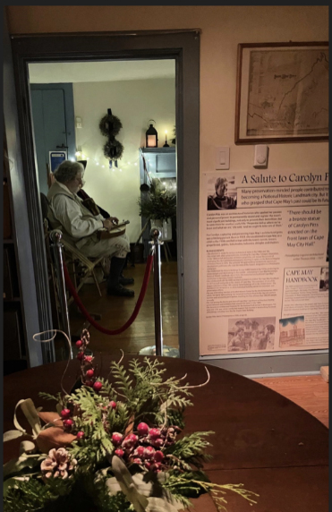 A speaker glimpsed through a door in the Colonial house